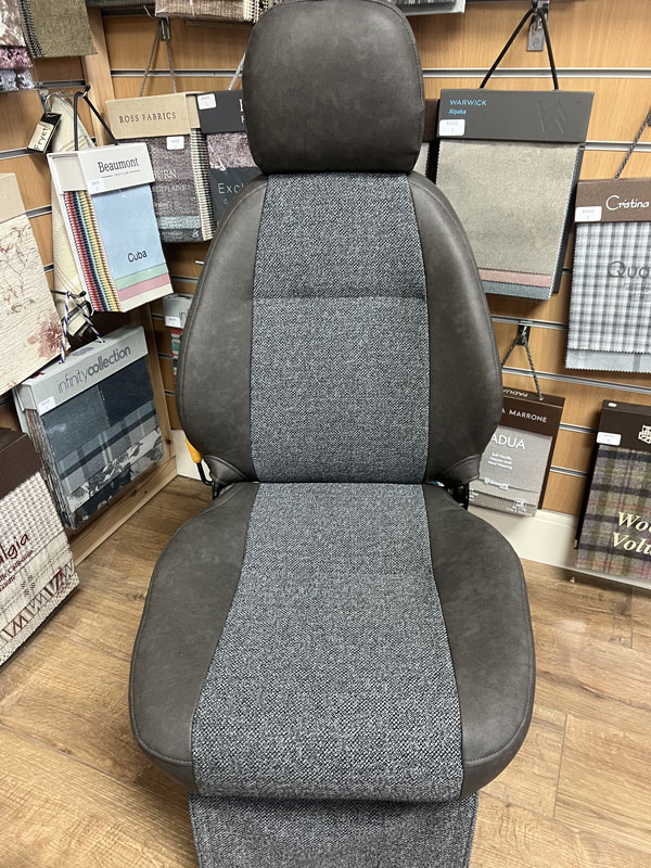 We have a motorhome cab seat on display to demonstrate a vinyl and fabric combination option